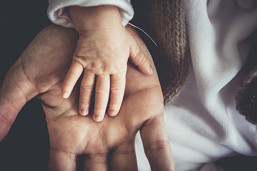 Image of child and elderly holding hands for NC BAM and Baptist Children Home of NC